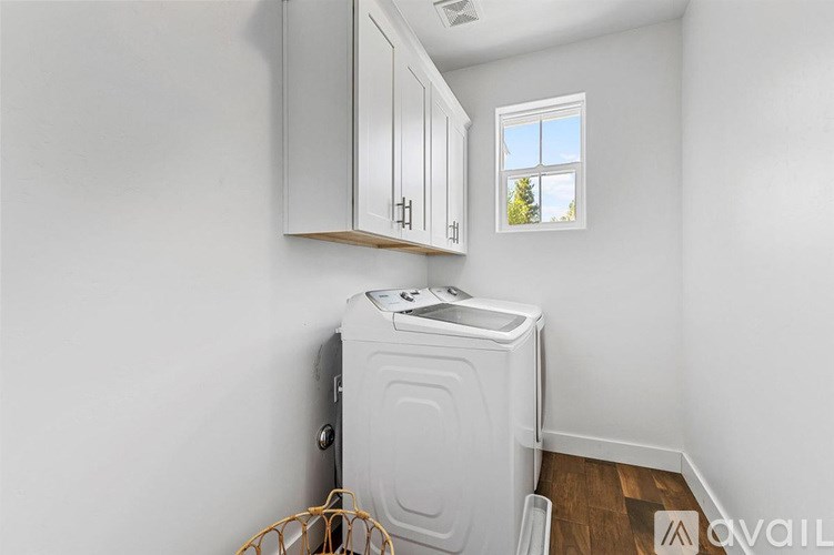 A small laundry room with a washer and dryer.