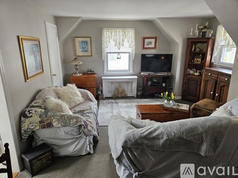 A living room with two grey couches and a television.