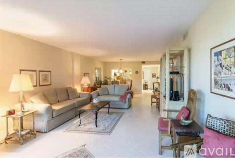 A living room with a white couch and a coffee table.