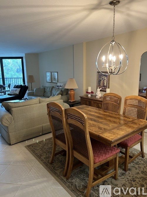 A dining room with a wooden table and chairs.