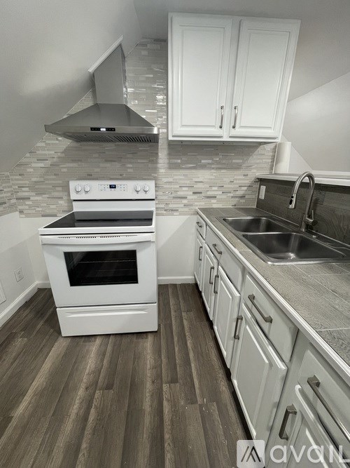 A white oven and sink in a kitchen.