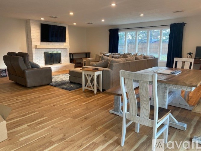 A living room with wooden floors and furniture.