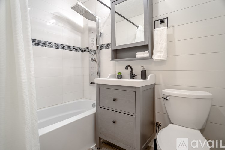 A backyard with a fence and trees in the background.