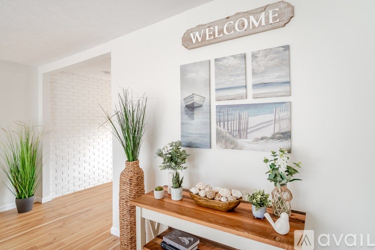 A room with a wooden table and a sign that says "Welcome".
