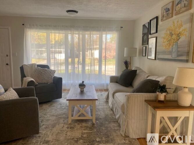 A living room with a couch, chair, and coffee table.