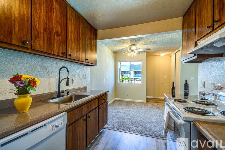 A kitchen with wooden cabinets and a sink.