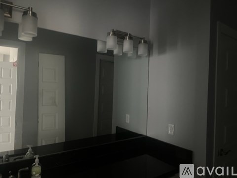 A room with a black countertop and a white door.