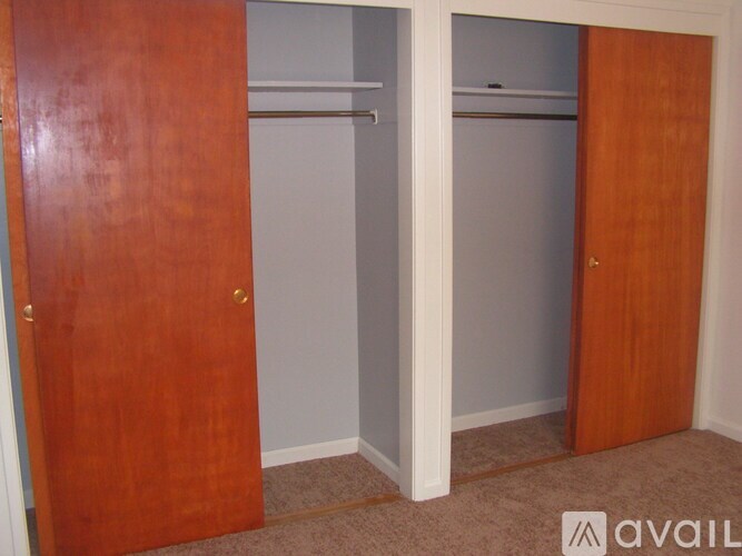 A room with two doors and a carpeted floor.