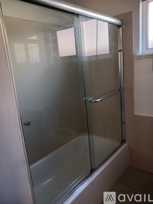 A glass shower door in a bathroom.