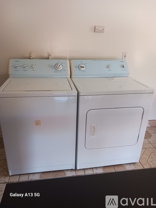 Two washing machines are placed next to each other.