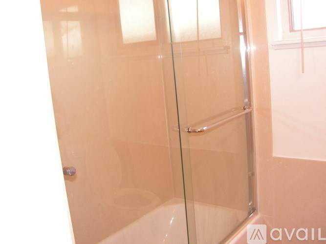 A glass shower door in a bathroom.