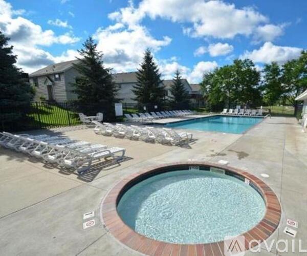A large outdoor swimming pool surrounded by sun loungers.