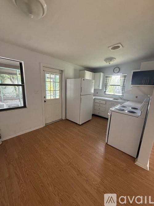 A room with wooden flooring and a ceiling fan.