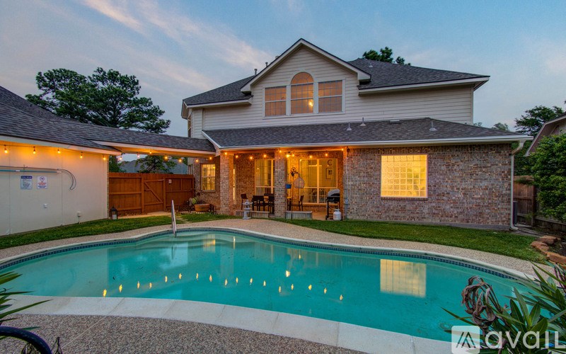 A house with a pool in front of it.