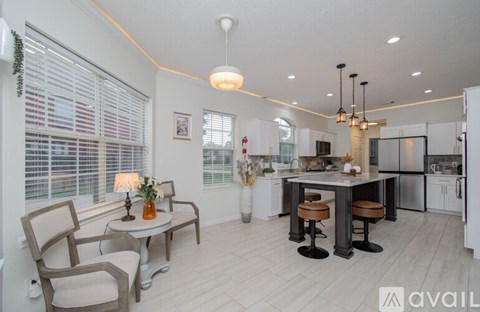A modern kitchen with a dining table and chairs.