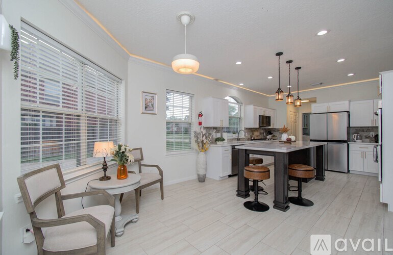 A modern kitchen with a dining table and chairs.