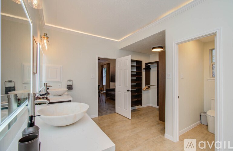 A bathroom with a white sink and a mirror.