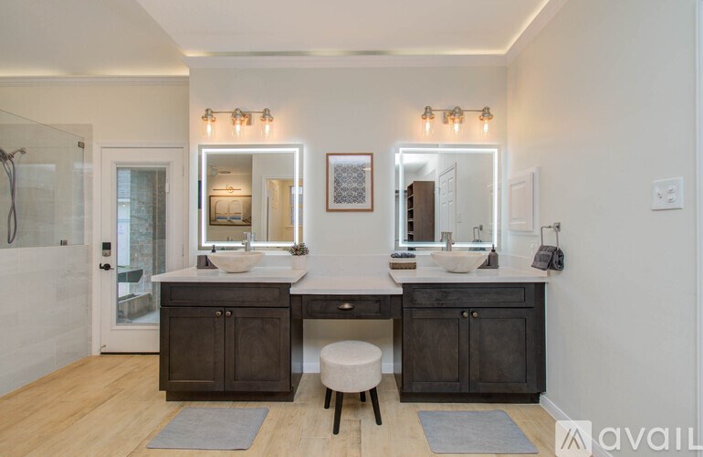 A bathroom with two sinks and a large mirror.