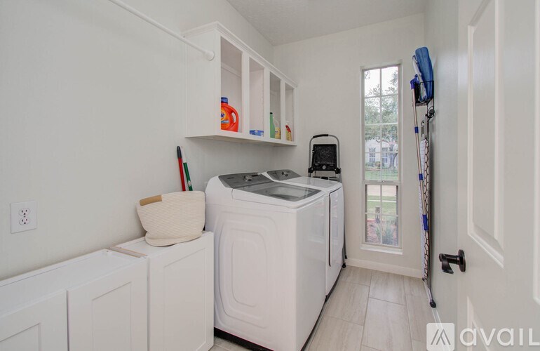 A white laundry room with a washer and dryer.
