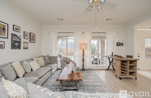 A living room with a grey sofa and a wooden coffee table.