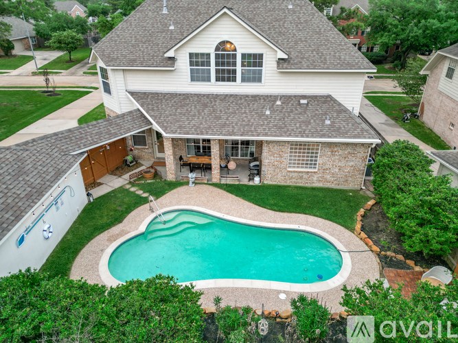 A house with a pool in the backyard.