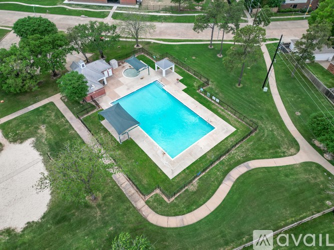 A backyard with a pool and a house.
