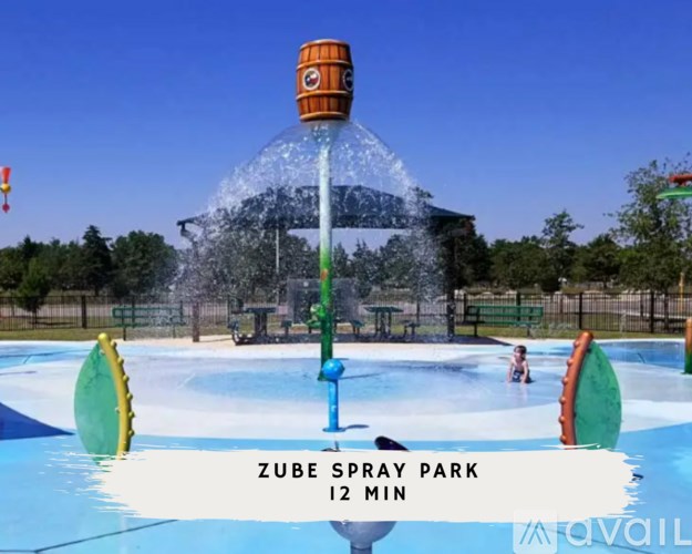 A water park with a sign that says ZUBE SPRAY PARK 12 MIN.