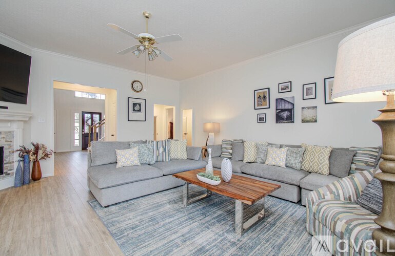 A living room with a grey couch and a coffee table.