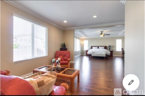 A living room with a red couch and a wooden coffee table.