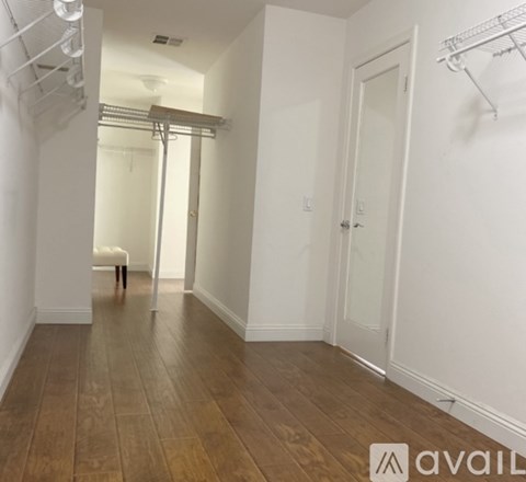 A room with a wooden floor and white walls.