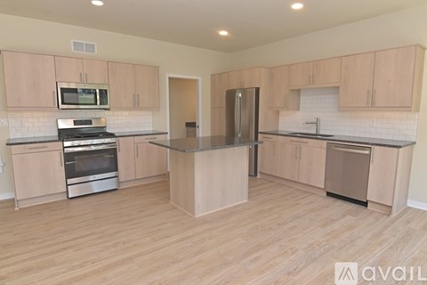 A kitchen with wooden cabinets and a central island.