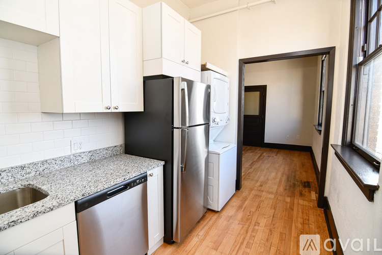 A kitchen with a stainless steel refrigerator, oven, and microwave.