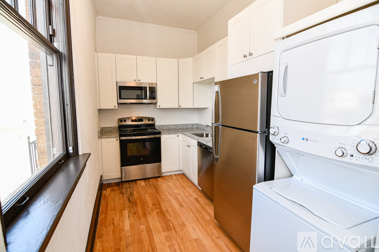 A kitchen with a stove, oven, refrigerator, and microwave.