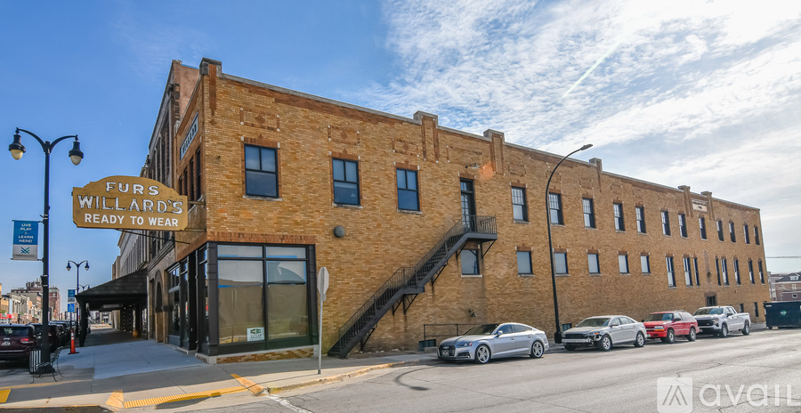 A street view of a building with the sign "FURS WILLARD READY TO WEAR" on the left side.