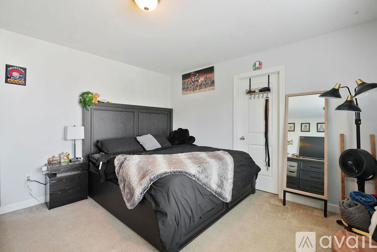 A bedroom with a large bed and a mirror on the wall.