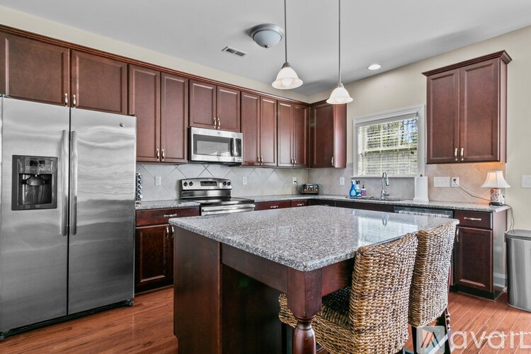 A kitchen with wooden cabinets and a granite countertop.
