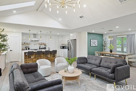A living room with a grey sofa and a coffee table.