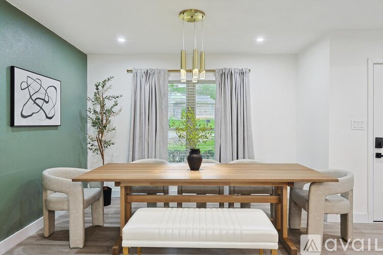 A dining room with a wooden table and chairs.