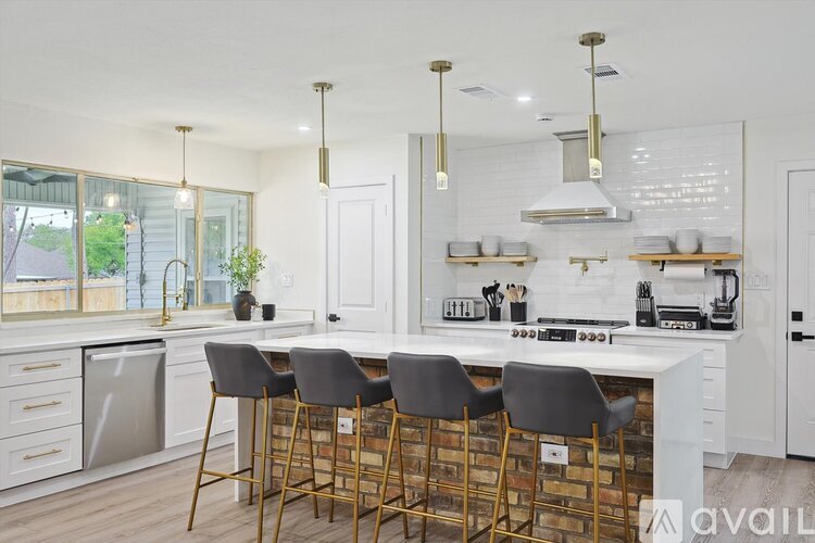A kitchen with white cabinets and a white counter top.