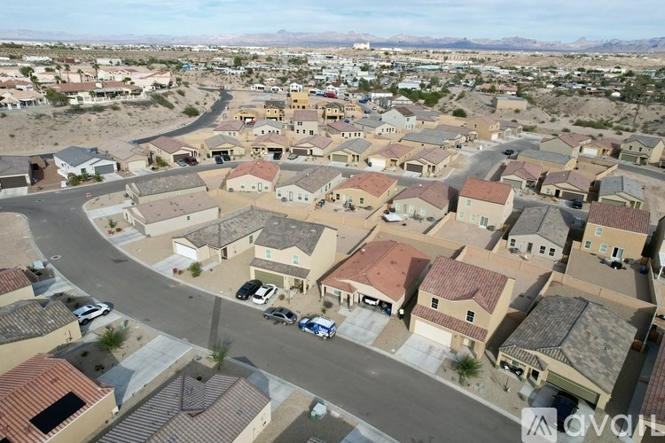A bird's eye view of a residential neighborhood with houses and cars.