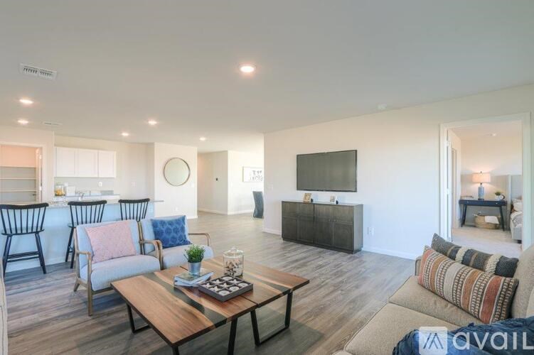 A living room with a wooden coffee table and a television.