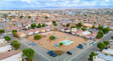 A bird's eye view of a residential area with houses, cars, and a playground.