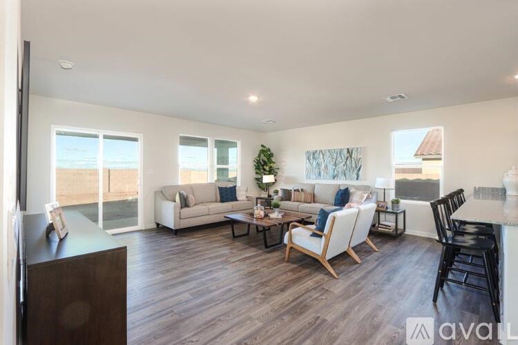 A living room with a white couch and a wooden floor.