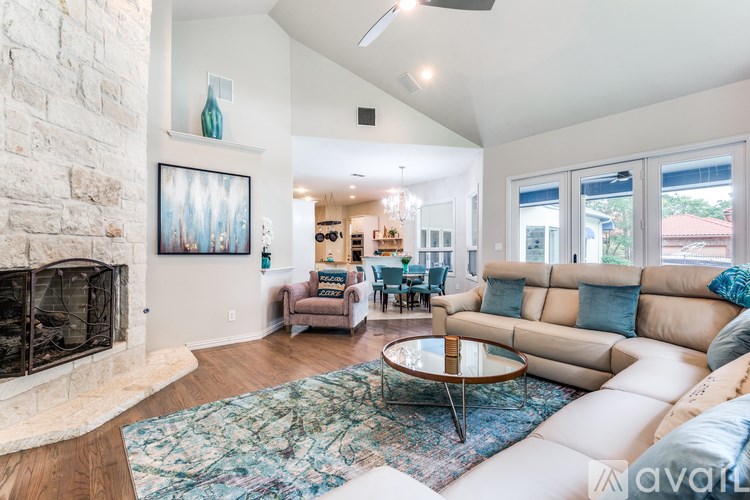 A living room with a fireplace and a painting on the wall.