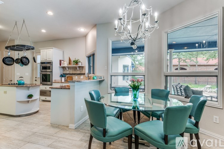 A modern kitchen with a dining table set for six.