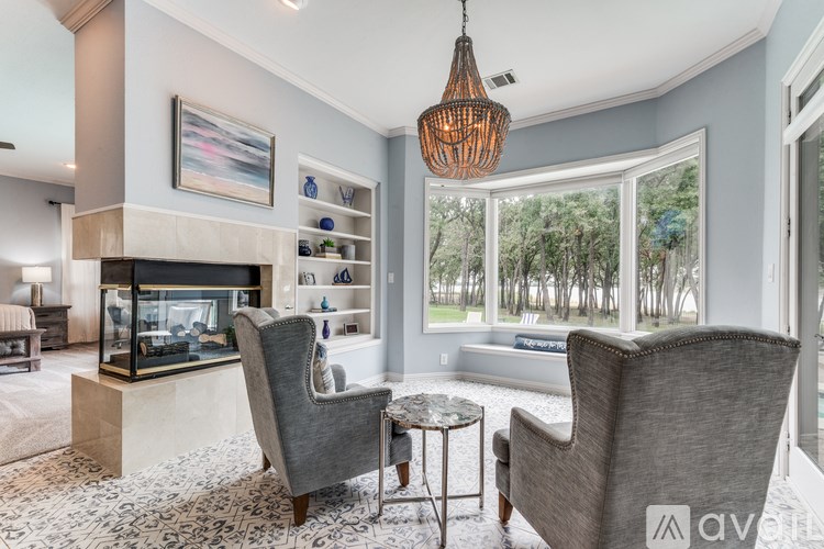 A living room with a grey sofa and a glass fireplace.