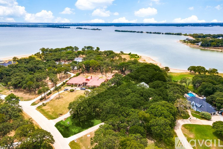 A bird's eye view of a residential area with a beach in the background.