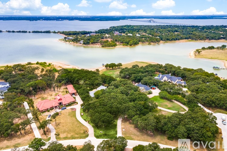 A bird's eye view of a residential area with a lake in the background.