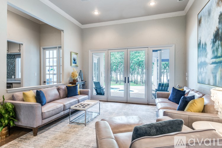 A living room with a couch, a coffee table, and a painting on the wall.