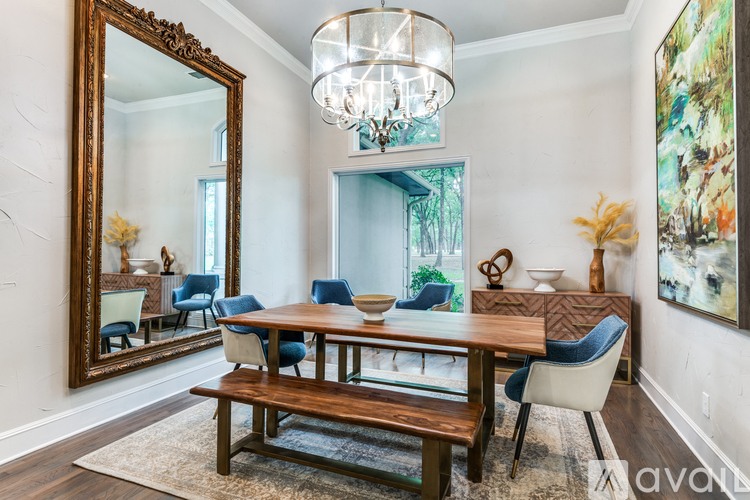 A dining room with a wooden table and blue chairs.